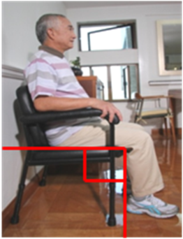 A man sitting on a chair with appropriate height and adequate back support, his knees are placed at right angle, and both feet are on the ground. The armrests of the chair help him rise from the chair.